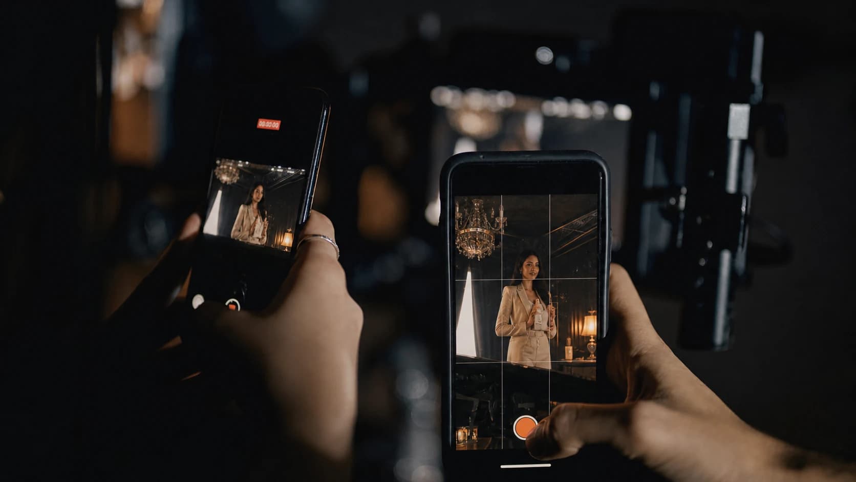 Two phones recording a cinematic social media campaign in a dark studio